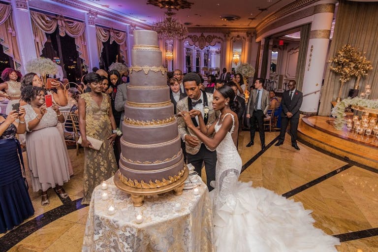 Bride and groom cutting the eight tier wedding cake | PartySlate