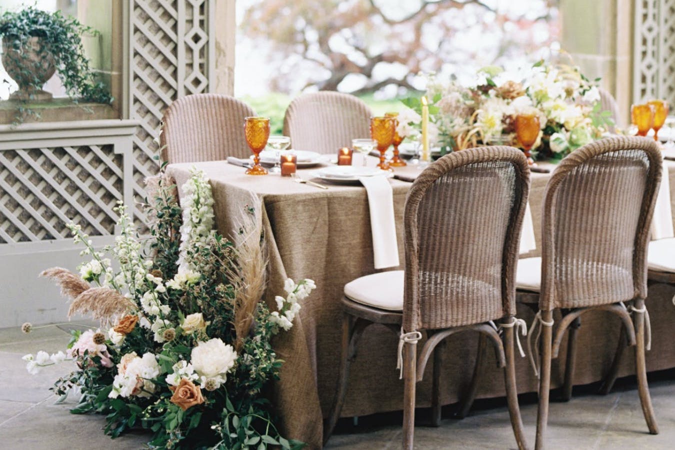 Simple boho-style wedding reception table with florals decor | PartySlate