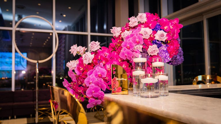 Cirque Du Sophia purple and pink flower arrangement | PartySlate