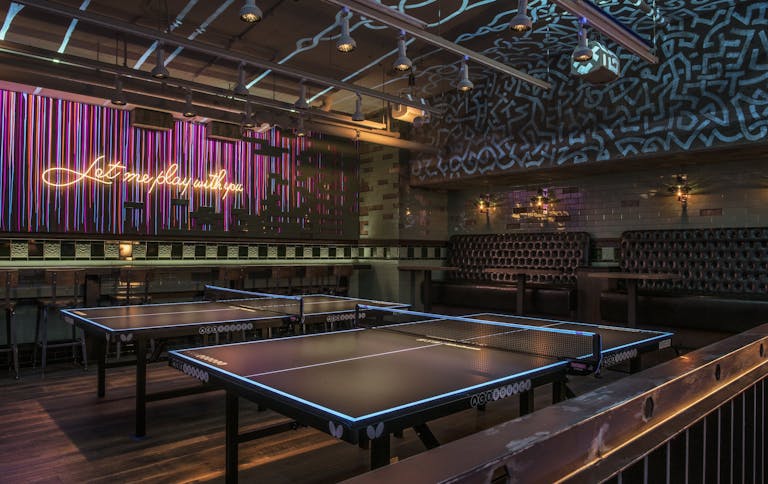 Private event space for your sweet sixteen with ping-pong tables, seating and abstract wall decor | PartySlate