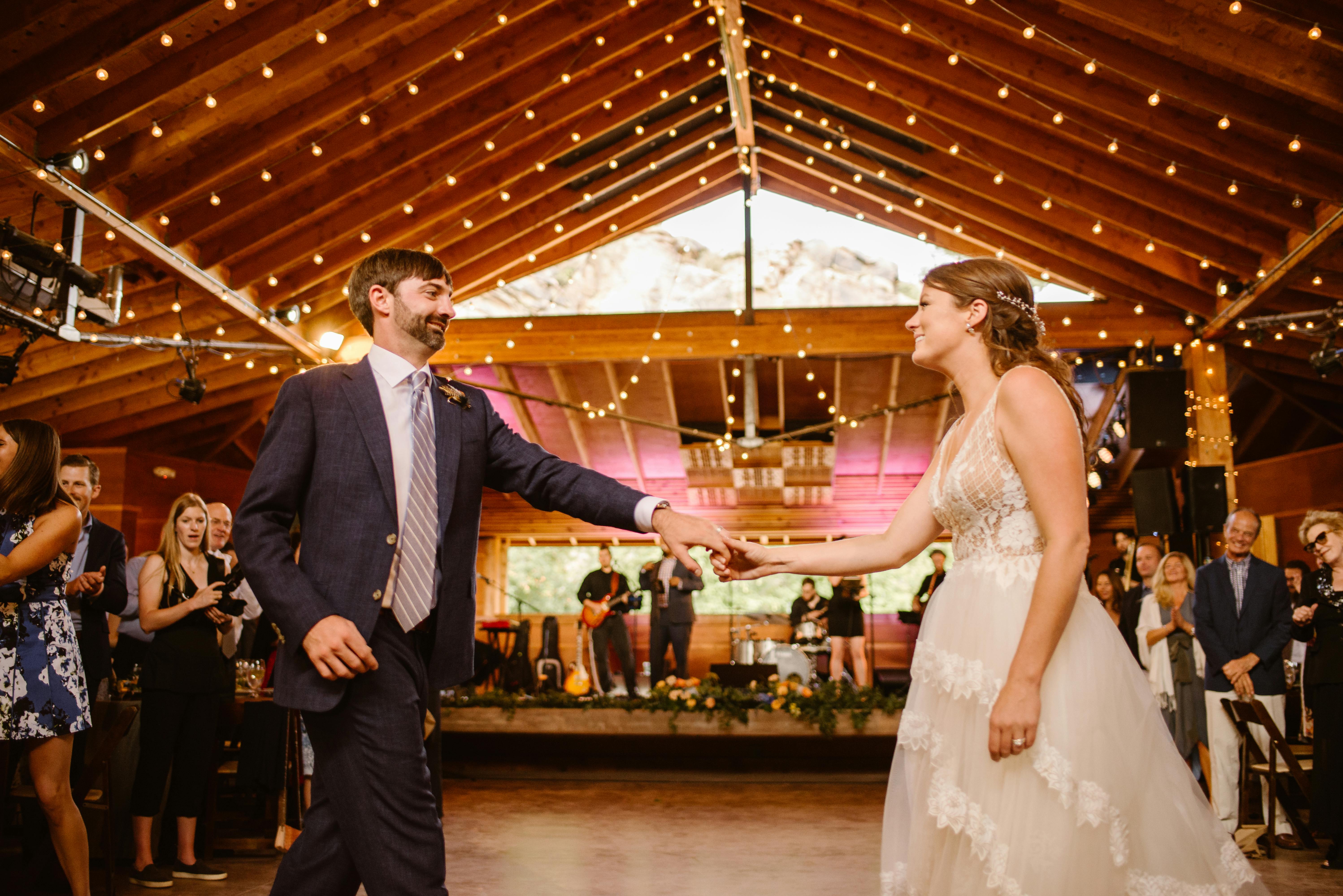 Chic wedding with fairy lights stringed across the ceiling in Lyons, CO | PartySlate