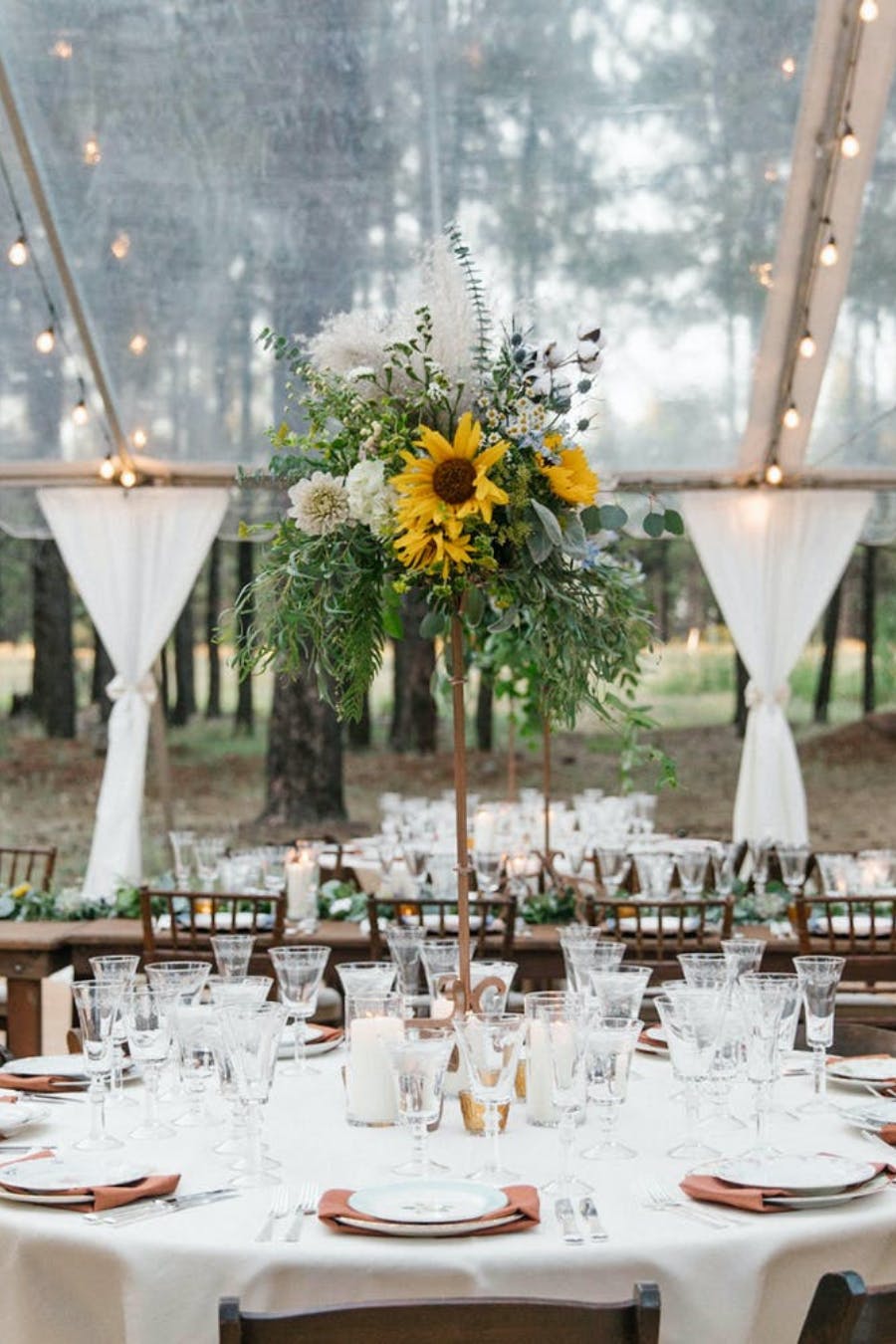 Outdoor tented wedding with Sunflower wedding centerpiece planned by Sally Arnold Events
