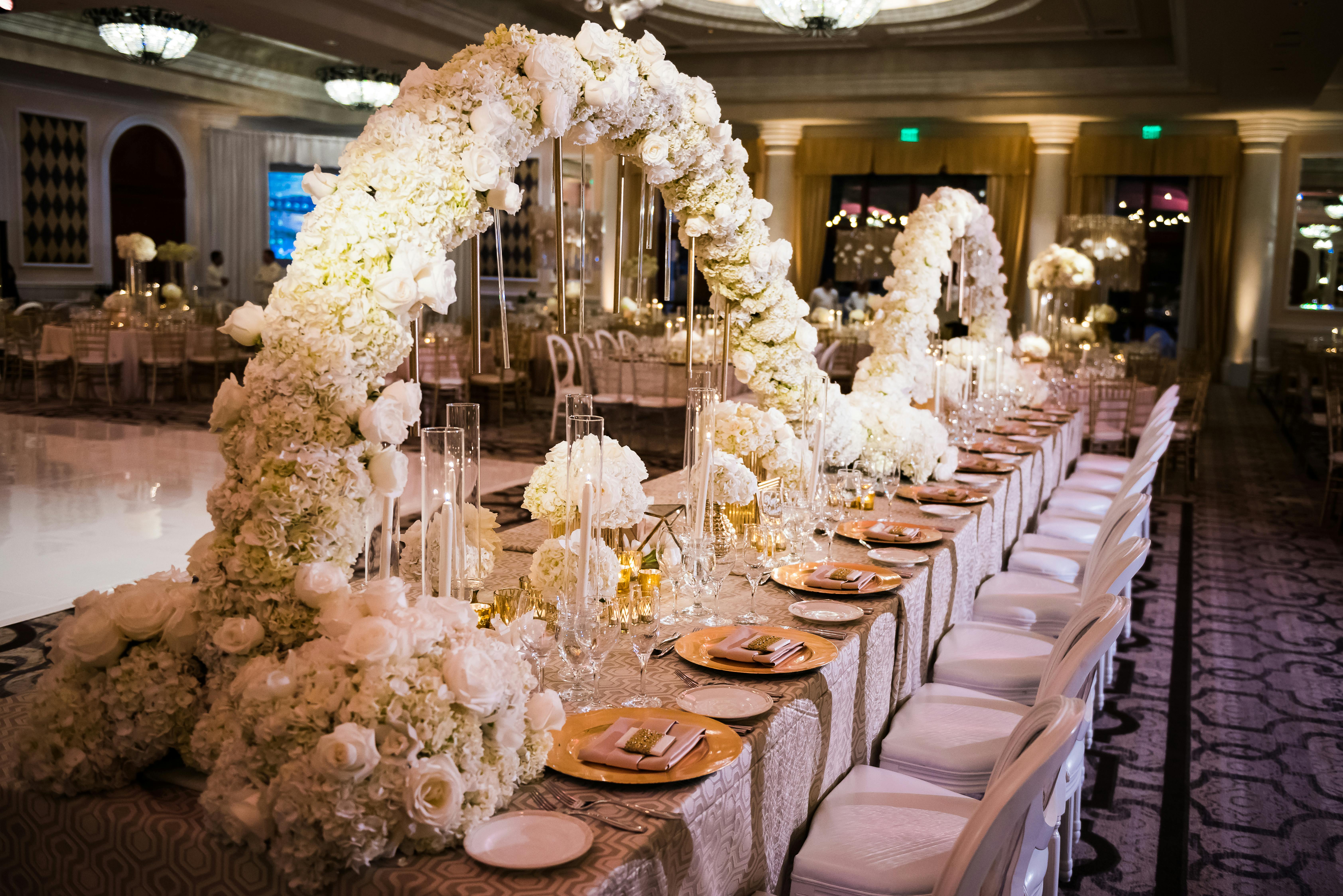 Long Wedding Reception Table with Undulating White Hydrangea Wedding Centerpieces