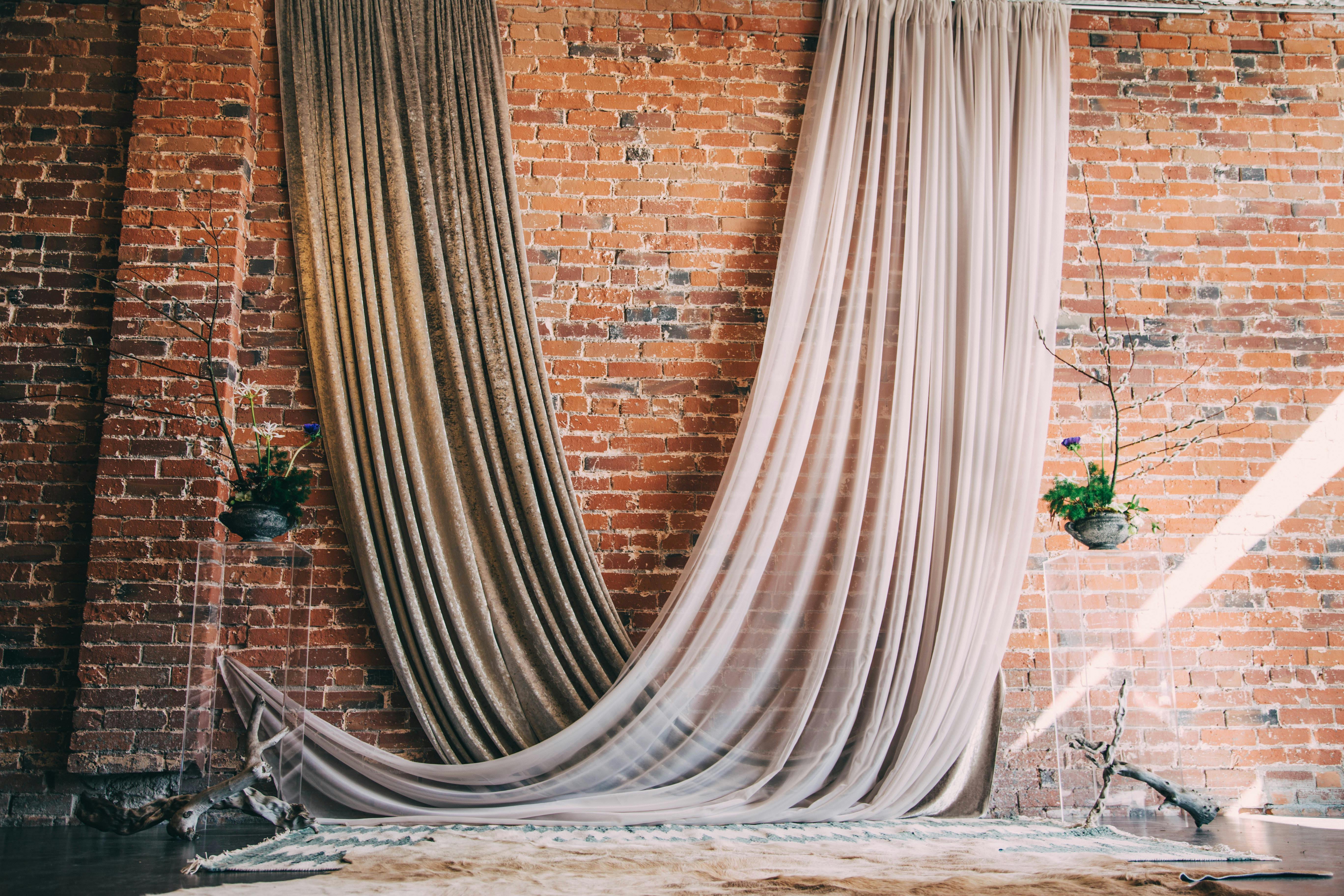 Early Spring Wedding Brick ceremonial Backdrop with Rose and Gold Drapery