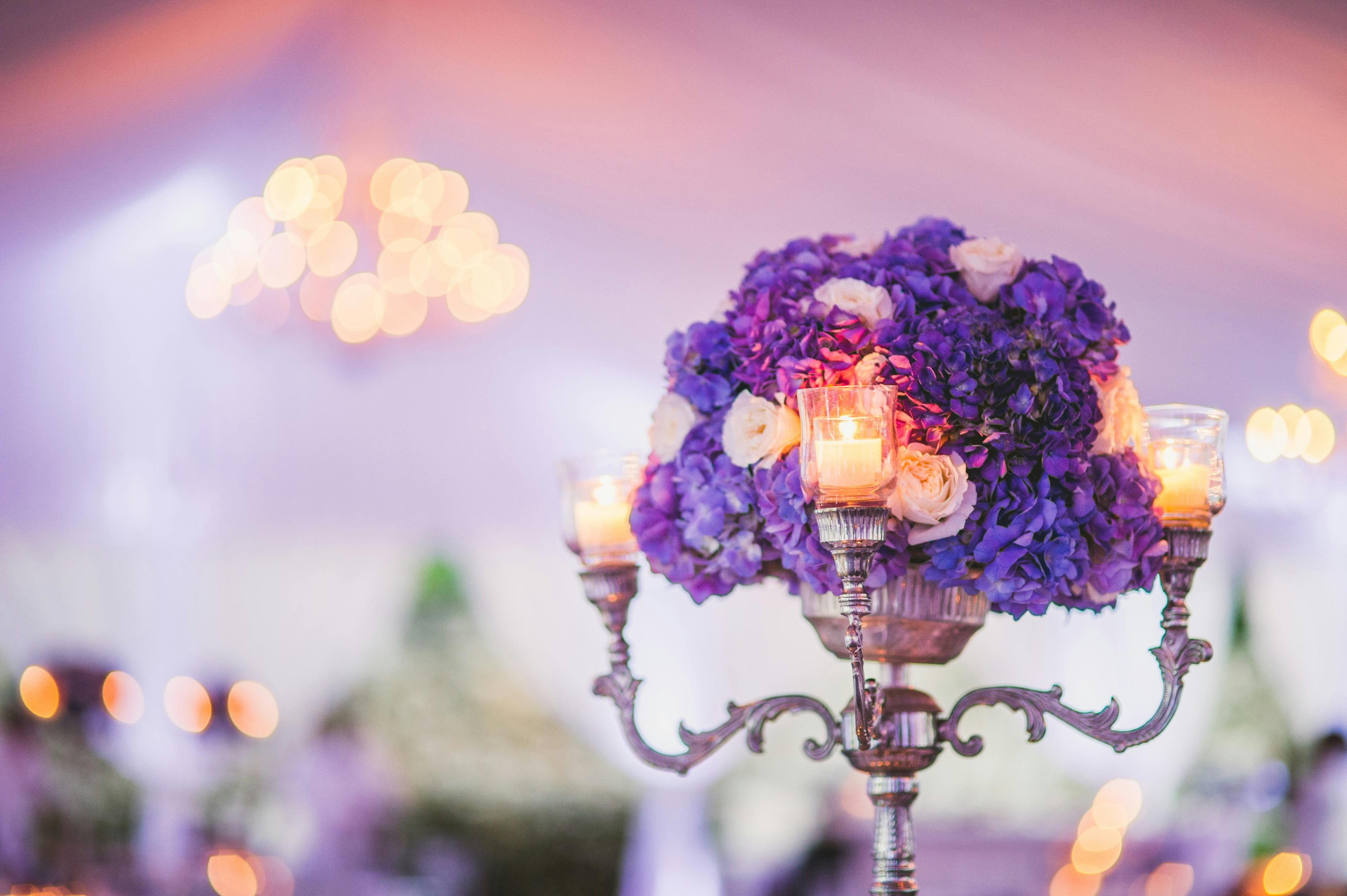 Close Up of Purple Hydrangea Wedding Centerpiece Featuring a Silver Candelabra