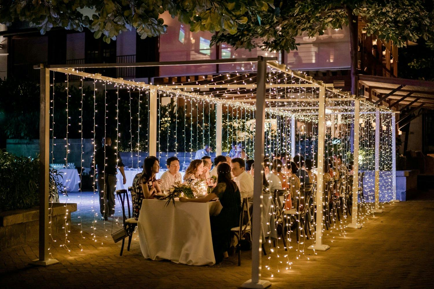 Cascading string lights forming into a small tent 2021 trend | PartySlate