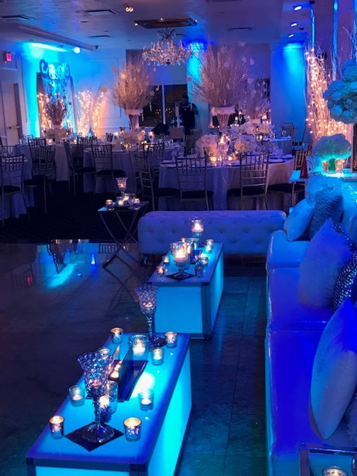 White lounge area with blue illuminating lights | PartySlate