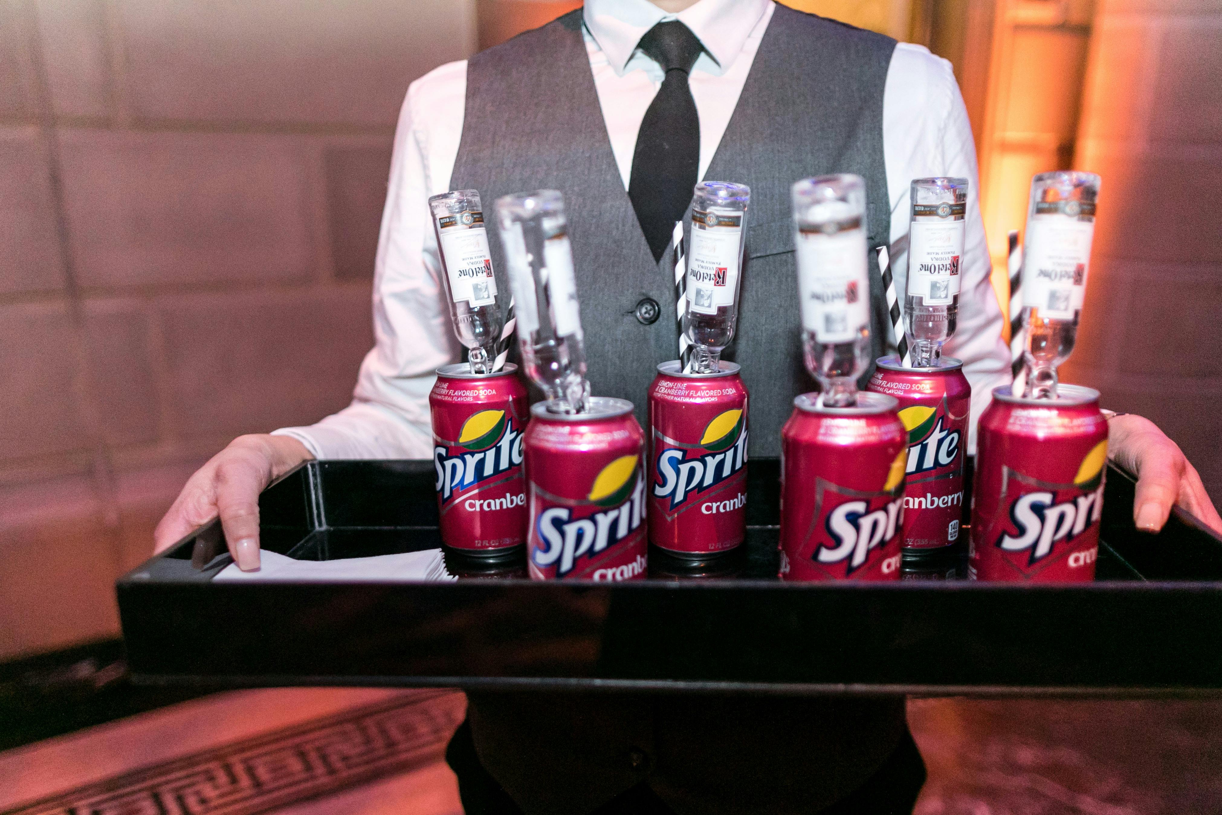 Extravagant 40th Birthday Celebration at Gotham Hall in New York, NY With Red Sprite Cans and Upside Down Mini Vodka Bottles | PartySlate