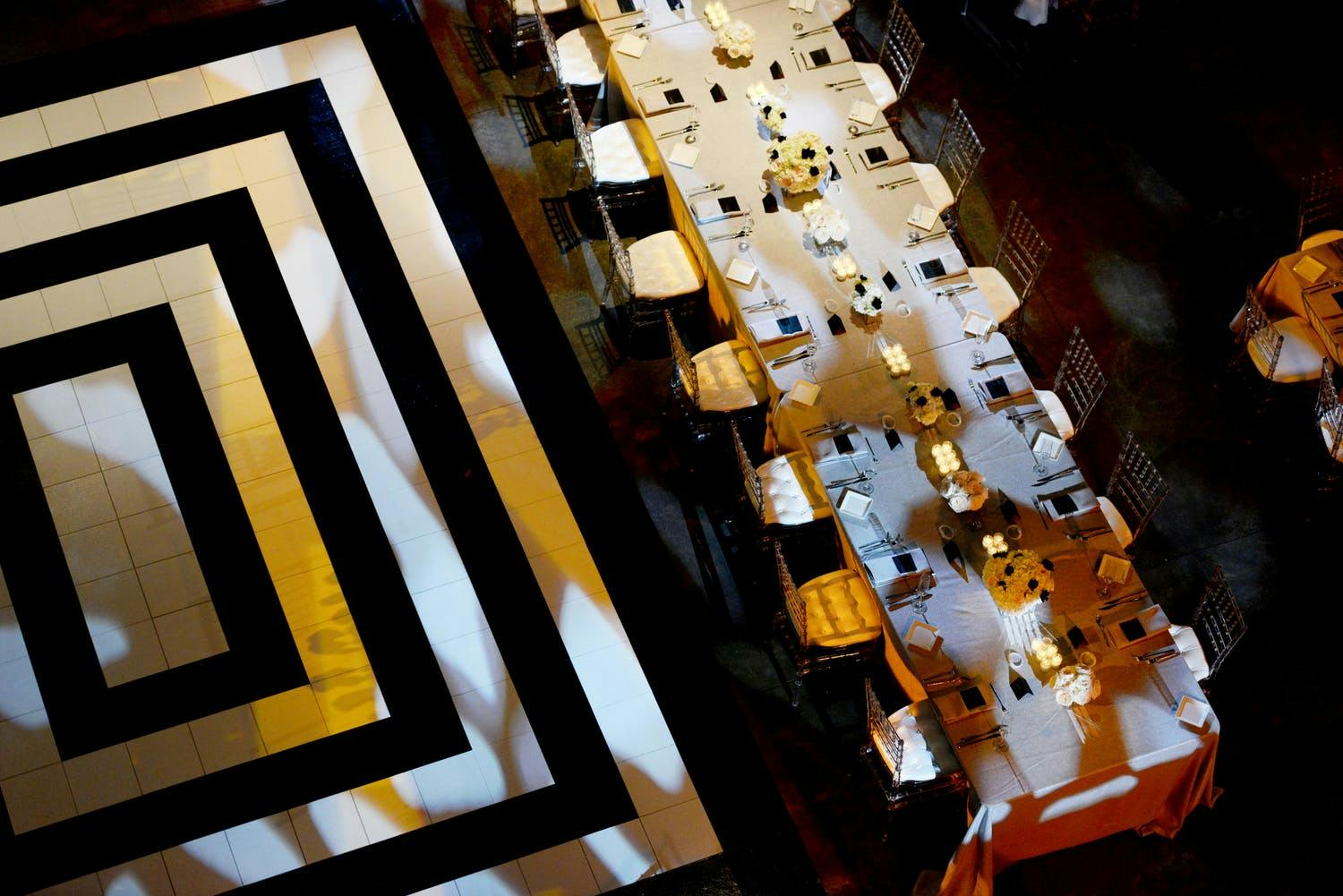 Wedding Reception Table With Black and White Dance Floor With Concentric Rectangles | PartySlate