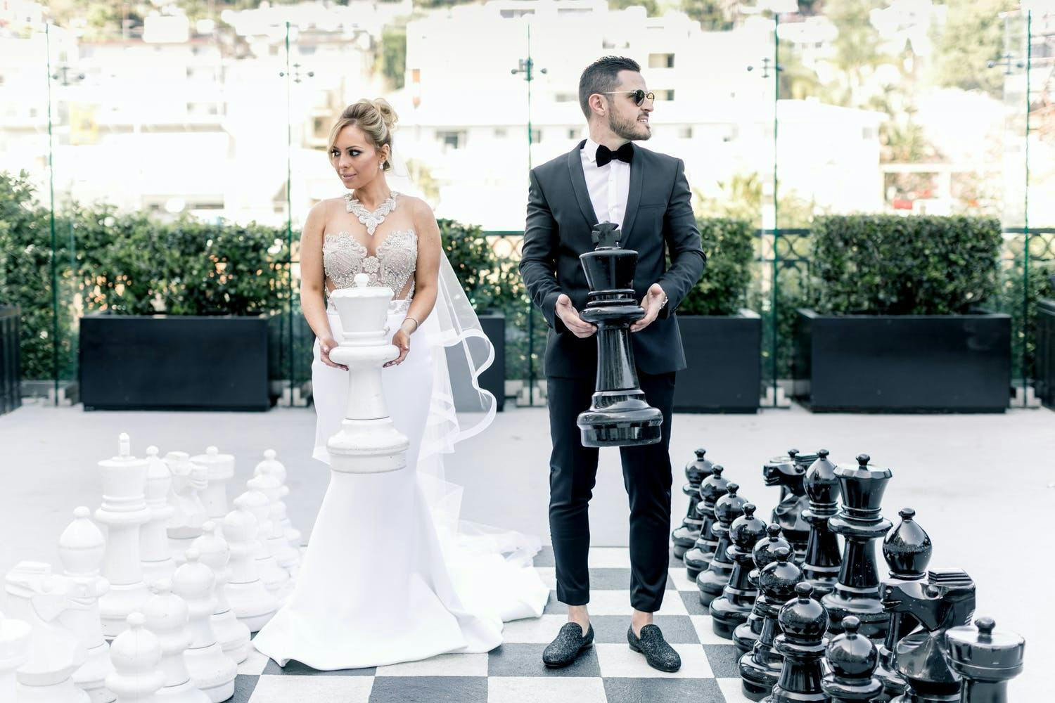 Bride and Groom Pose With Larger than Life Chess Board | PartySlate