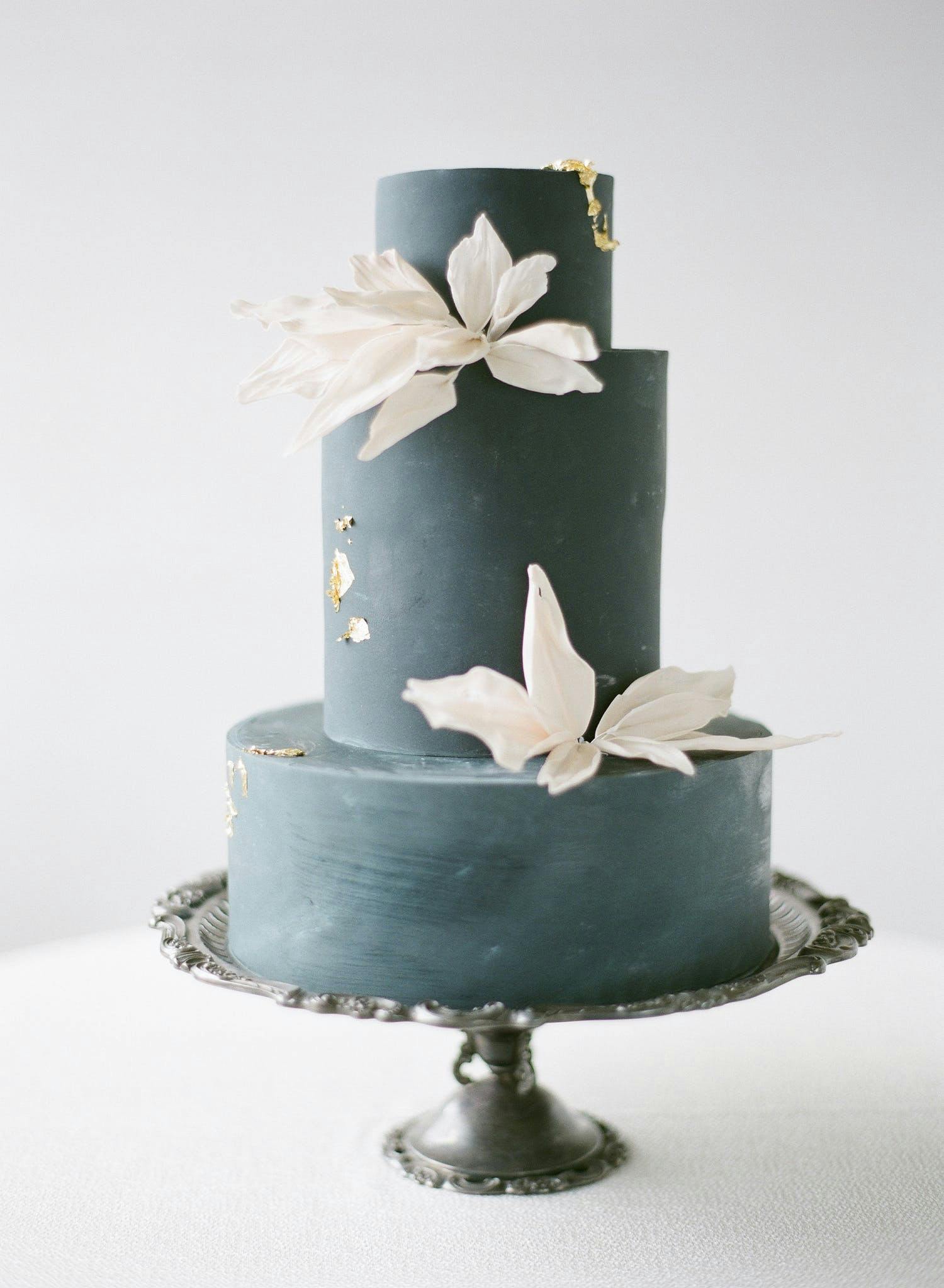 Black Monochrome Wedding Cake With Gold Details and White Blooms | PartySlate