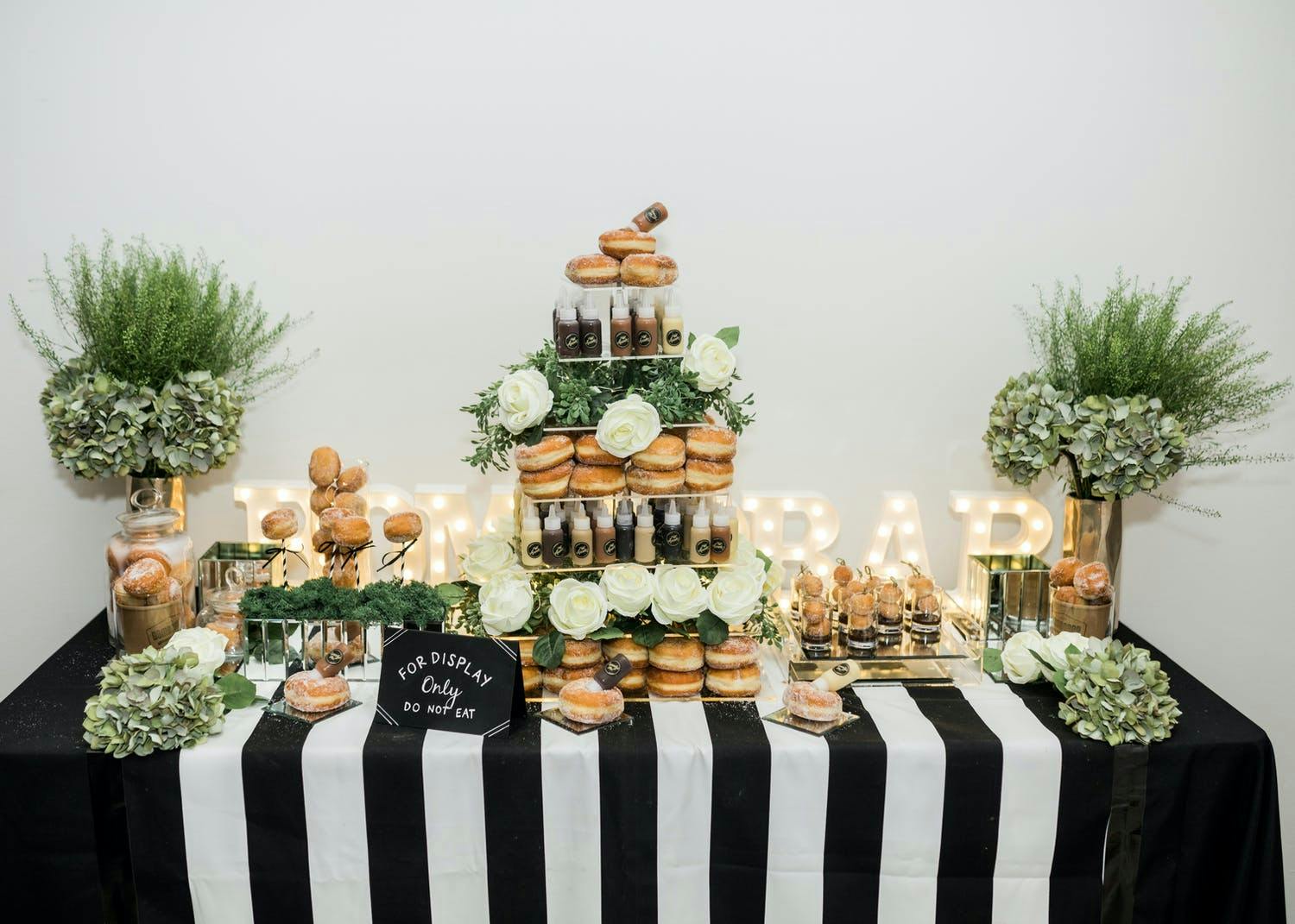 Wedding Donut Display With Black and White Striped Linen | PartySlate