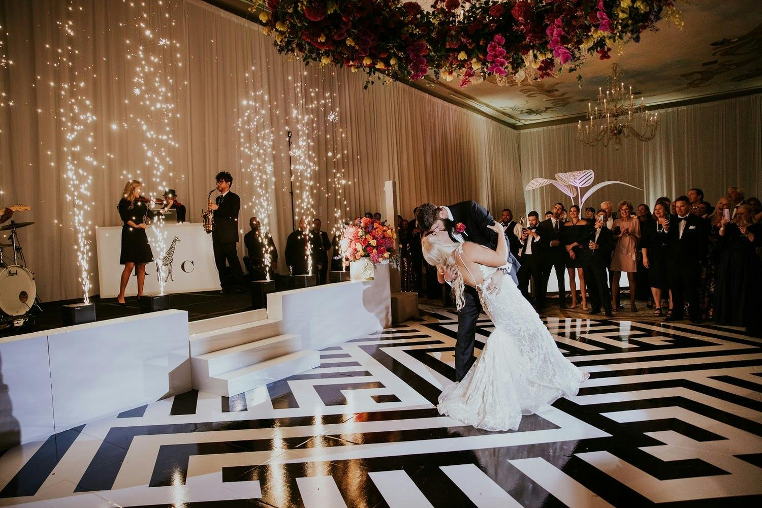 Black and White Art Deco Dance Floor With Cold Fireworks and Colorful Wreath Ceiling Installation | PartySlate
