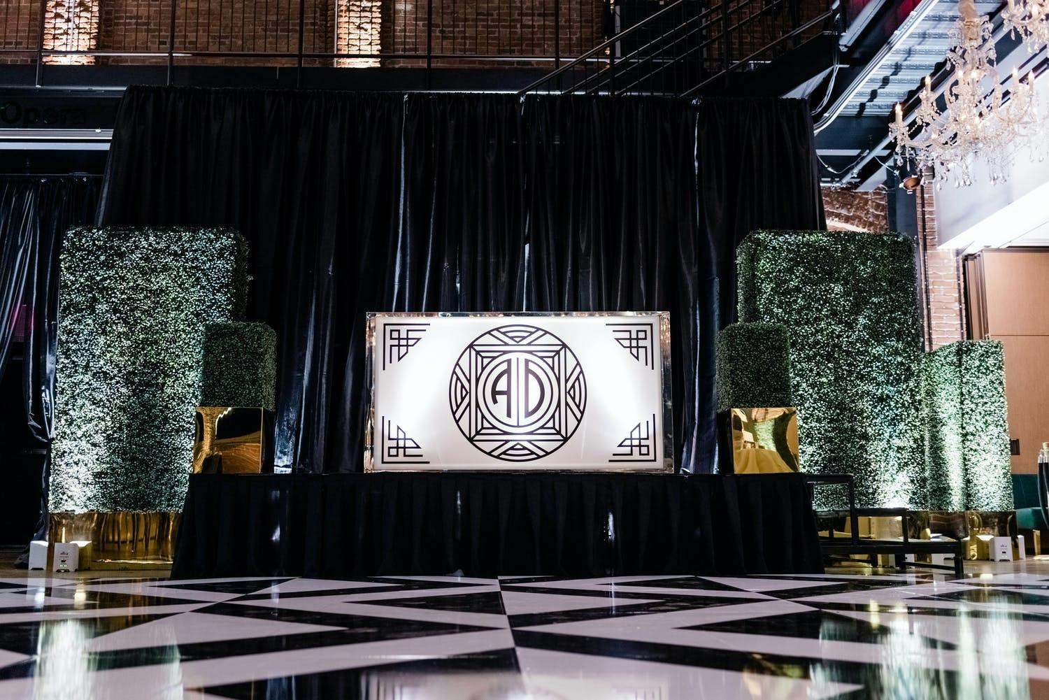 Black and White Wedding With Art Deco Dance Floor and Backdrop as Well as Boxwood Décor | PartySlate