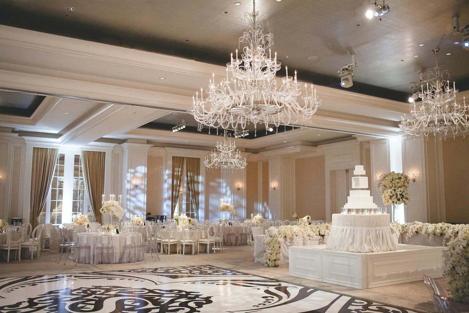 Ballroom Wedding With Glittering Chandeliers and Black and White Decal Dance Floor | PartySlate