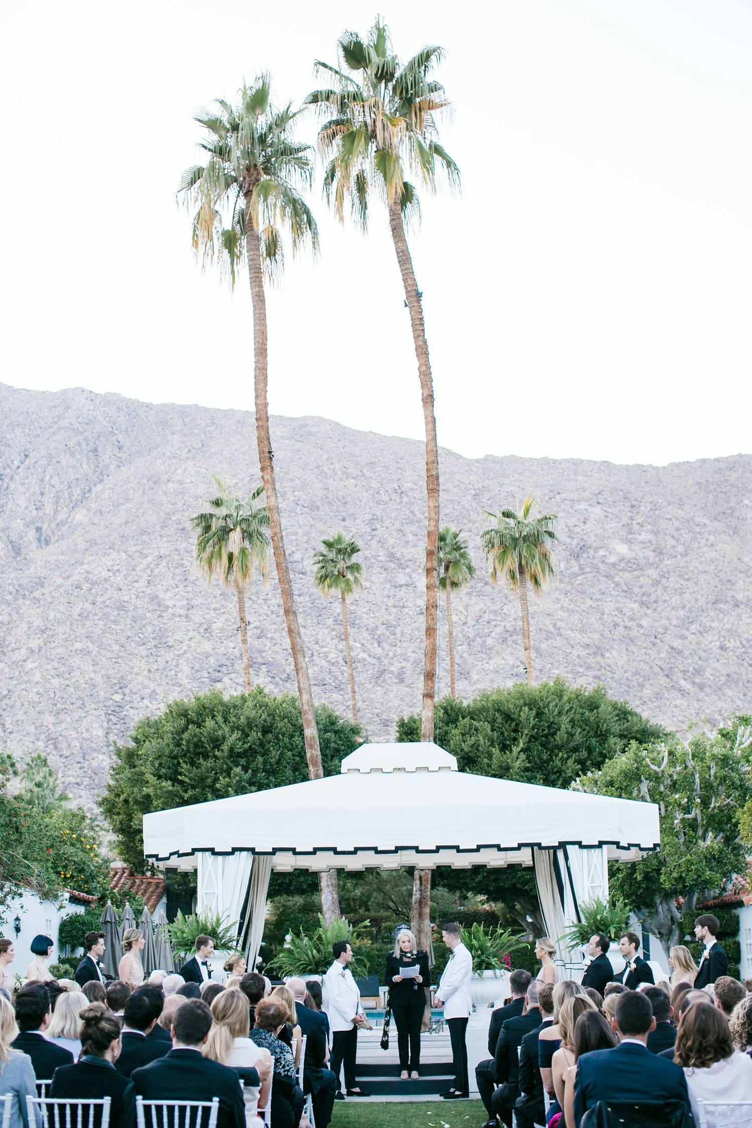 Outdoor Palm Springs Wedding Ceremony With Black and White Wedding Canopy | PartySlate