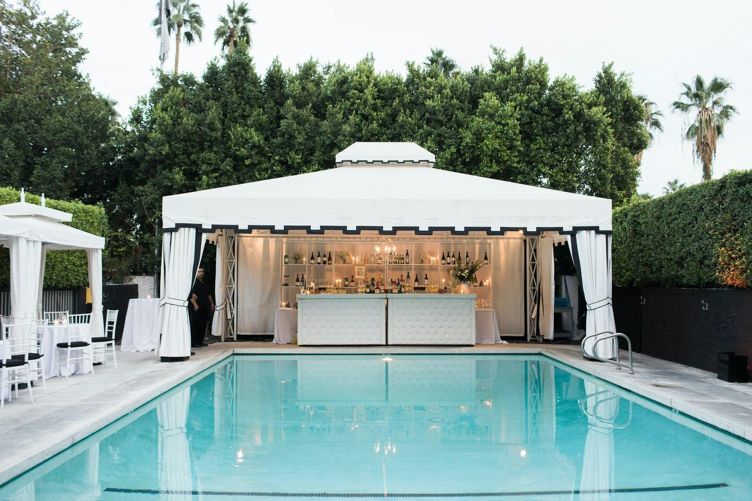 Pool Area with Black and White Cabana Bar Area | PartySlate