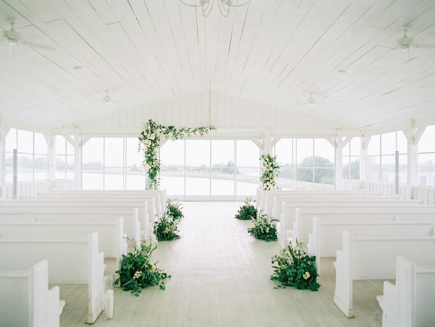 Modern Minimalist Wedding Ceremony in All-White Space With Simple Greenery Décor | PartySlate