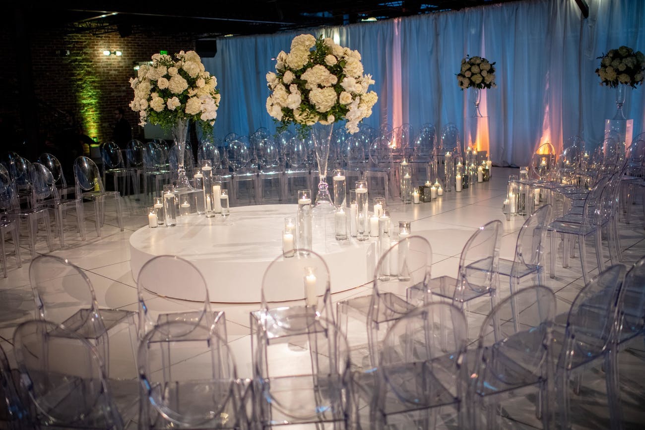 Acrylic see-through chairs at modern wedding reception | PartySlate