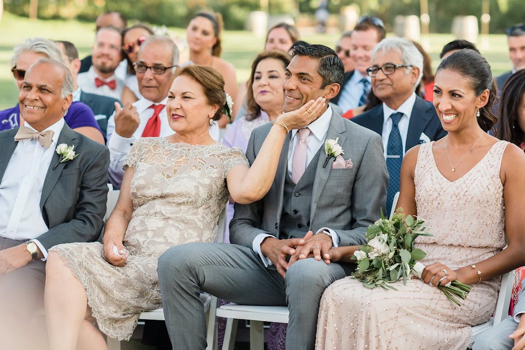 Wife Lovingly Pats Husband's Cheek as They Watch Child Get Married | PartySlate