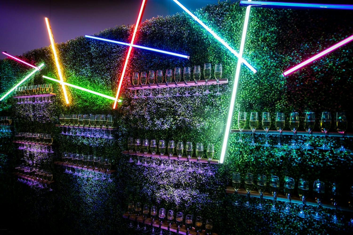 Champagne Wall with Colorful Laser Lights at Neon-Themed Gala | PartySlate
