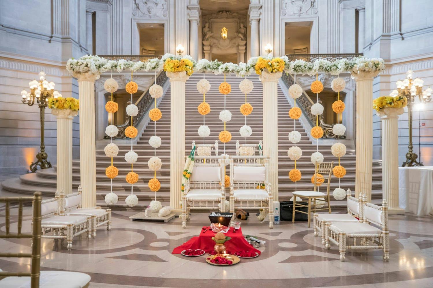 Unique Wedding Ceremony Backdrop with Yellow and White Rose Pom-Poms | PartySlate