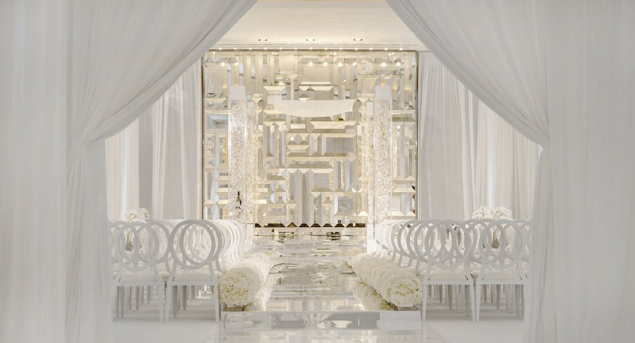 Modern Wedding Ceremony With Mirrored Backdrop and All-White Décor | PartySlate