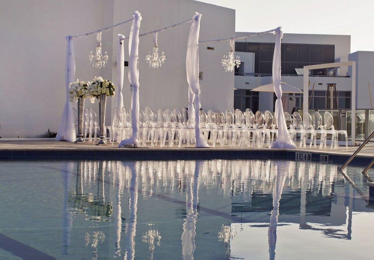 Towering floral arrangements at modern wedding | PartySlate