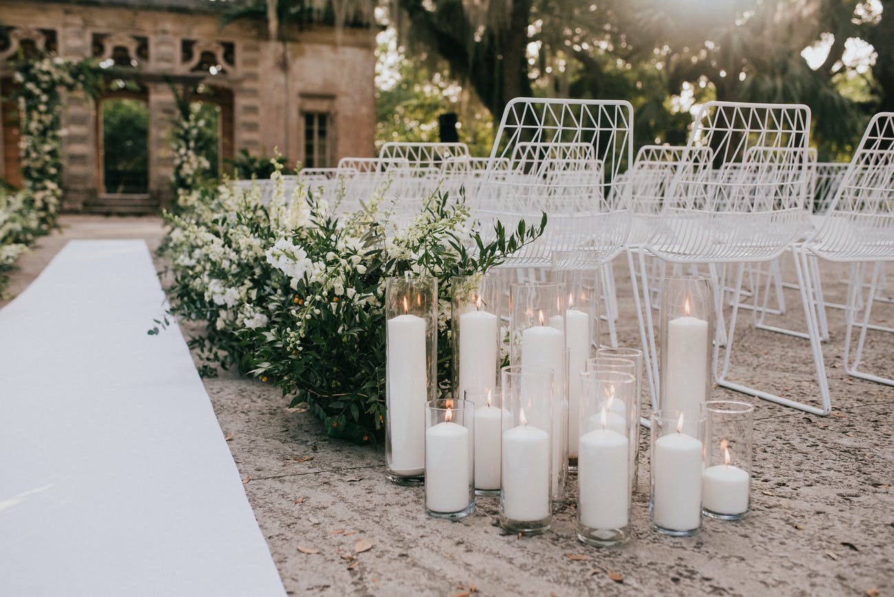 Clear glass candle holder with white large candles | PartySlate