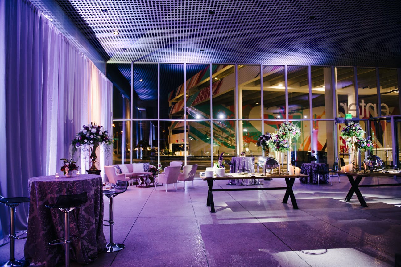 Vibrant purple uplighting for a modern wedding display | PartySlate