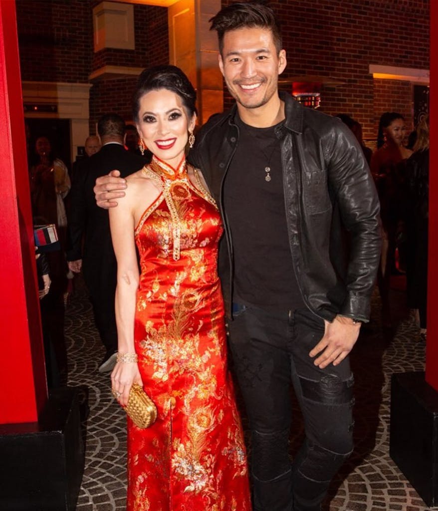 2 Bling Empire cast members pose for a pictureat a party