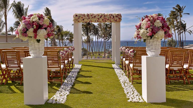 Hawaii wedding with pink and white florals and stone accents | PartySlate