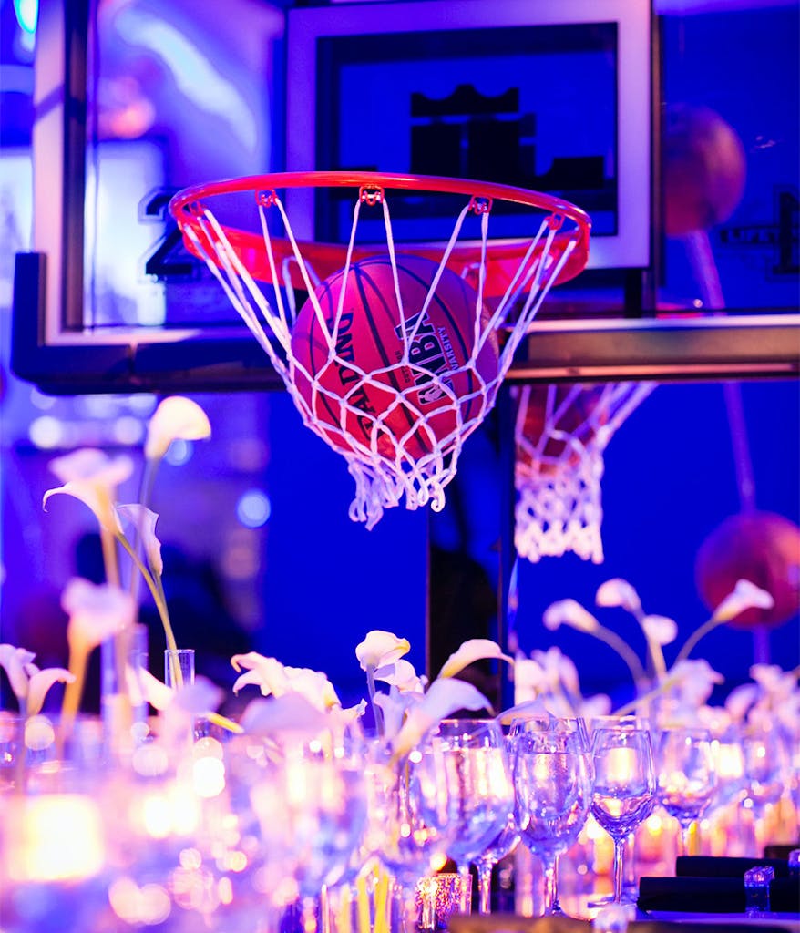 centerpiece at a blue Bar Mitzvah with basketball hoop and basketball décor
