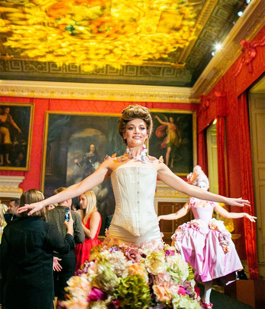 party at Kensington palace with red walls and lit up ceilings