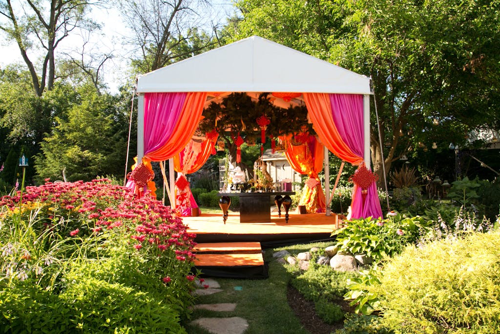 Colorful cabana with hot pink and bright orange draping | PartySlate
