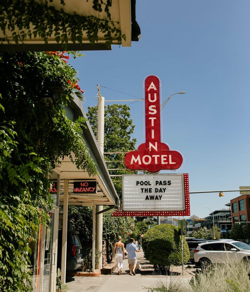 Photo of an Austin motel with a sign for a pool party