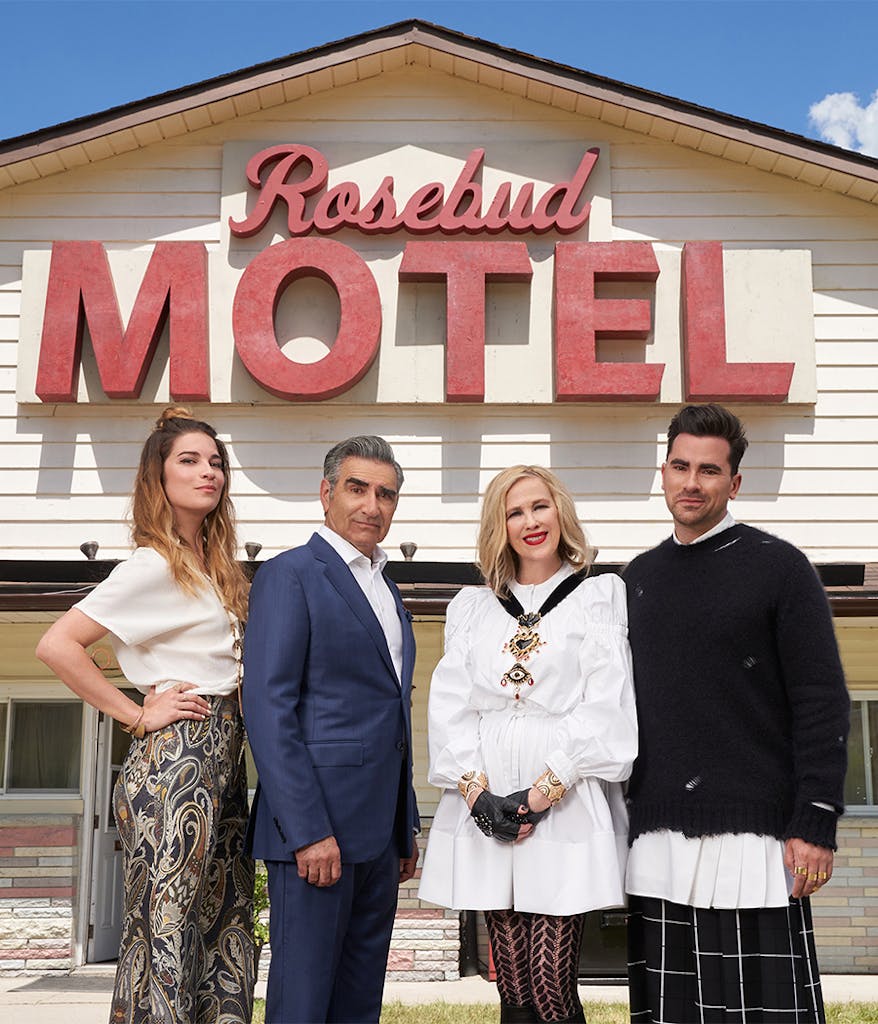 Cast members of Schitt's Creek in front of the Rosebud Motel