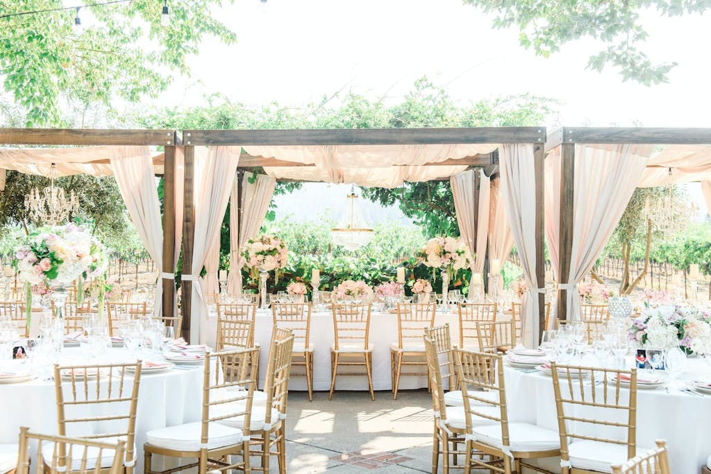 Wedding Cabana Tent With Blush Drapery in Garden Setting | PartySlate