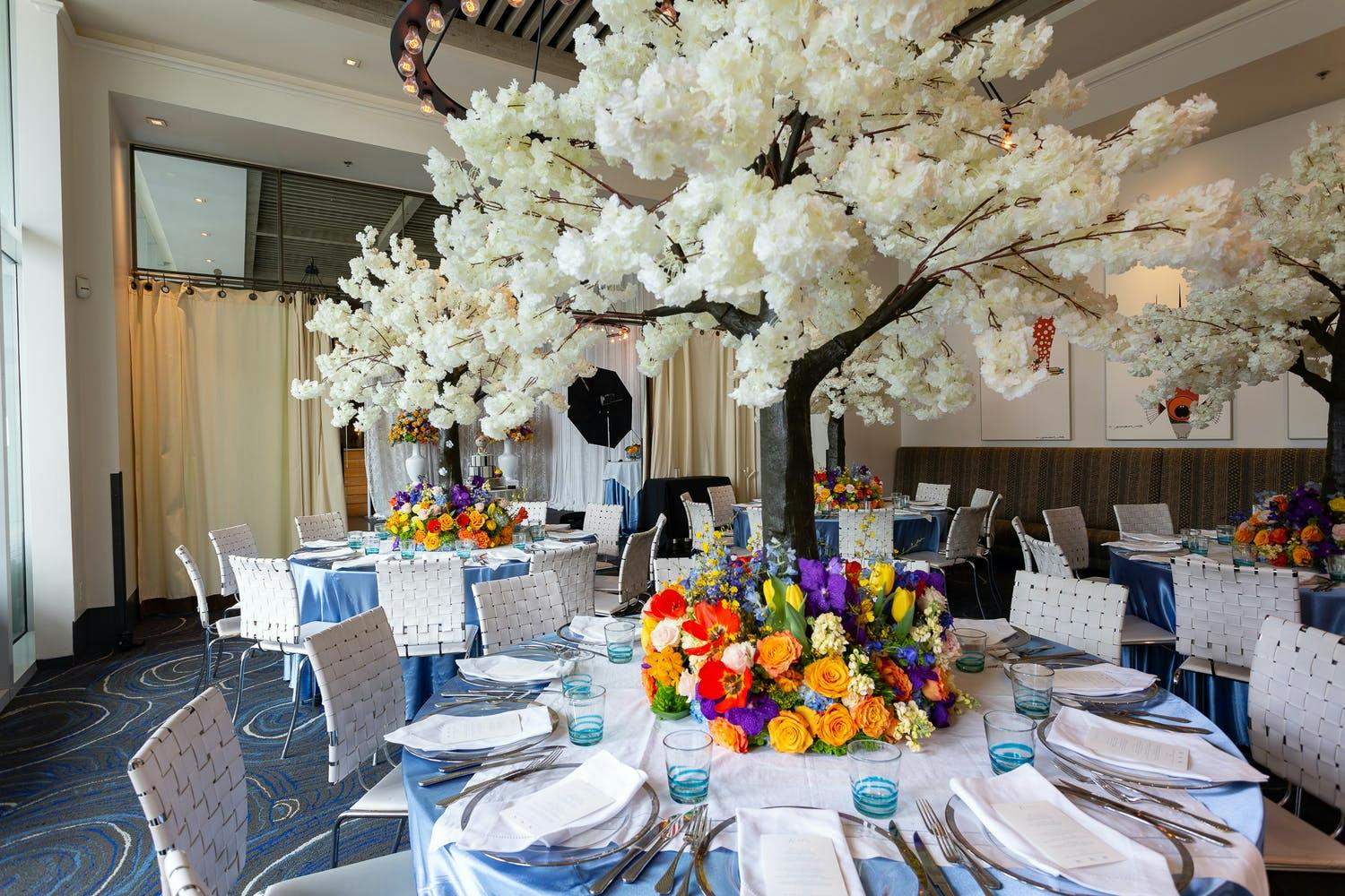 Baby Shower With White Flower Tree Top Centerpieces Surrounded By Colorful Floral Wreaths | PartySlate