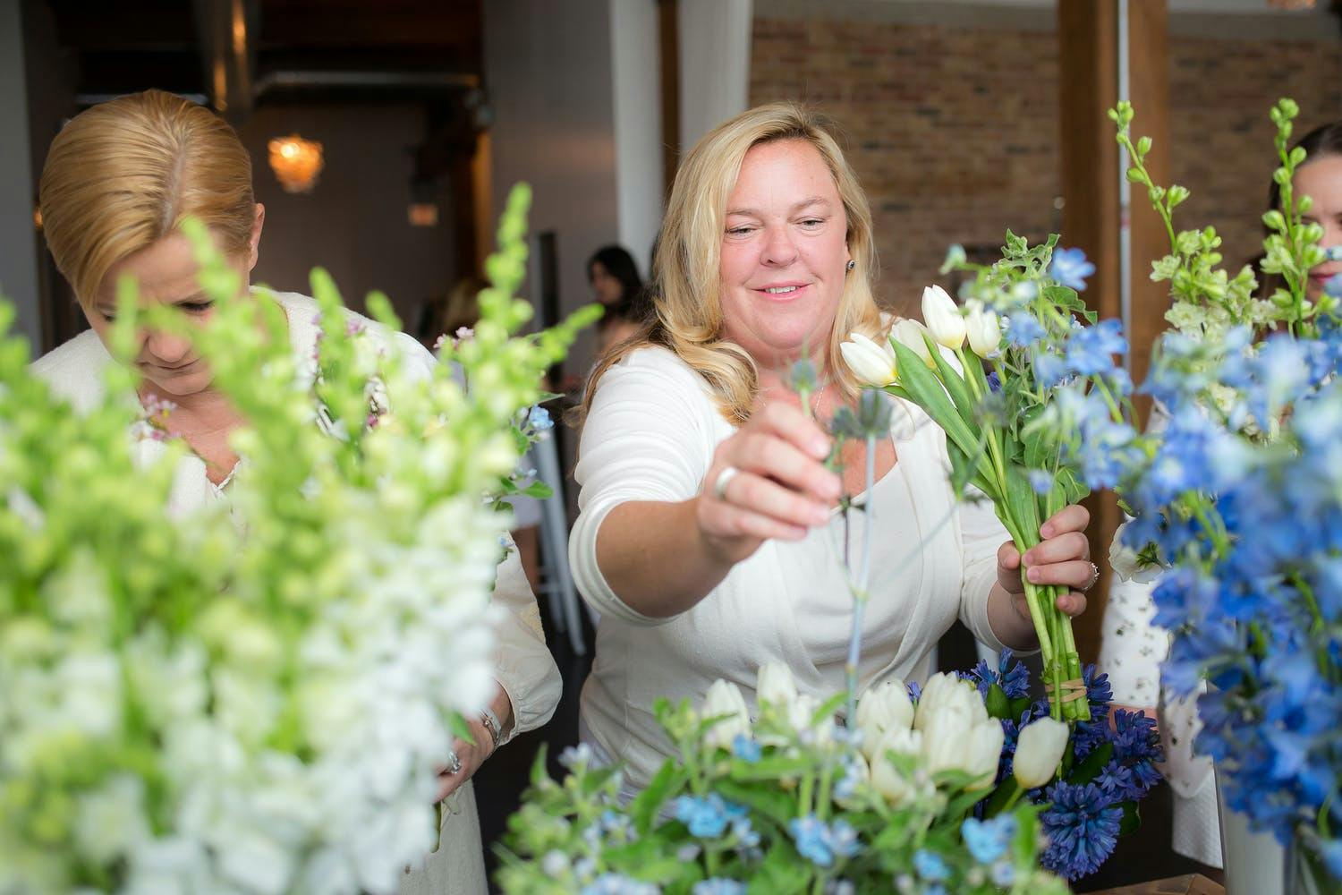 Two Women at Build Your Own Bouquet Station at Baby Shower | PartySlate