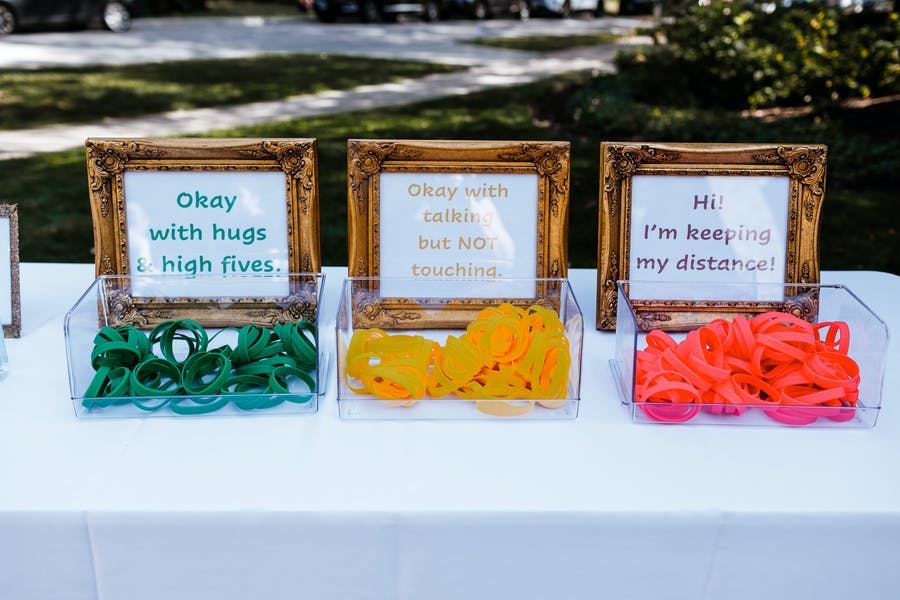 Three different colored wristbands to notion your comfortable levels at a micro wedding | PartySlate