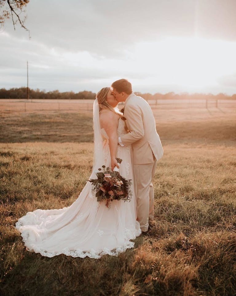 Bride and Groom Kiss at The Texana Grounds at The Grand Texana, a Wedding Venue in Houston | PartySlate