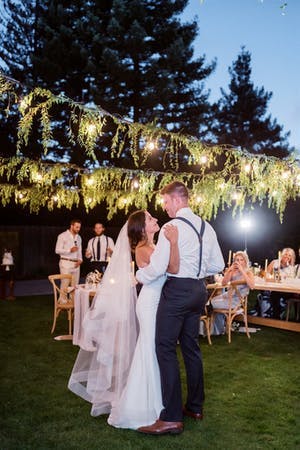 Backyard micro wedding with vines and twinkly lights | PartySlate