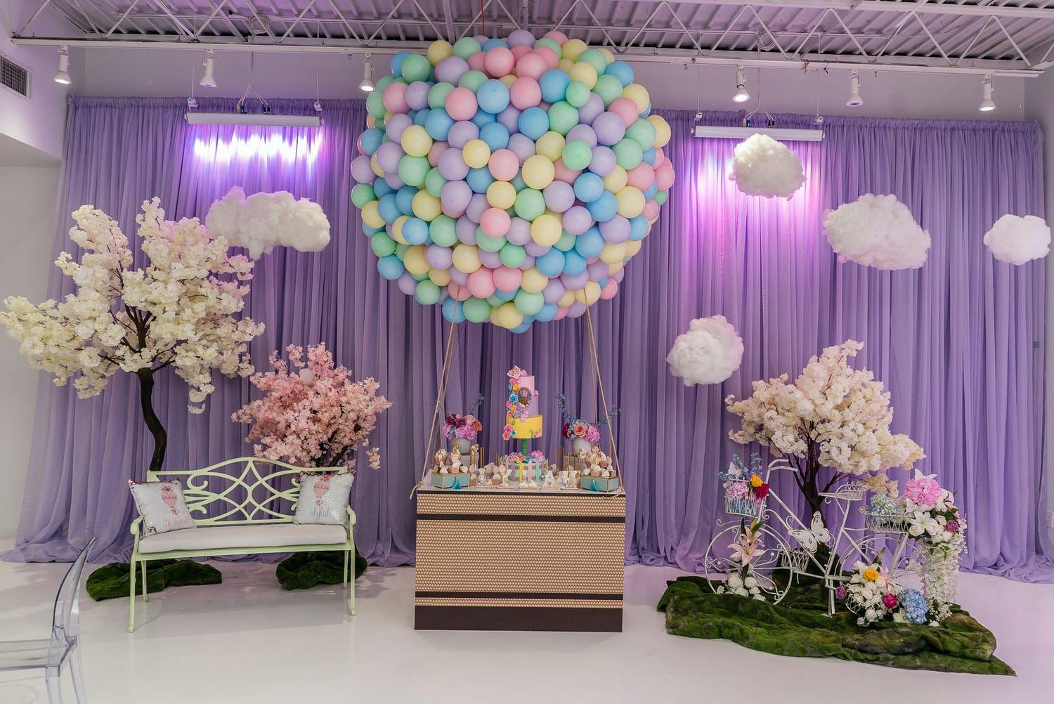 Hot Air Balloon-Themed Baby Shower with Violet Uplighting and Giant Hot Air Balloon Installation Made With Balloons | PartySlate