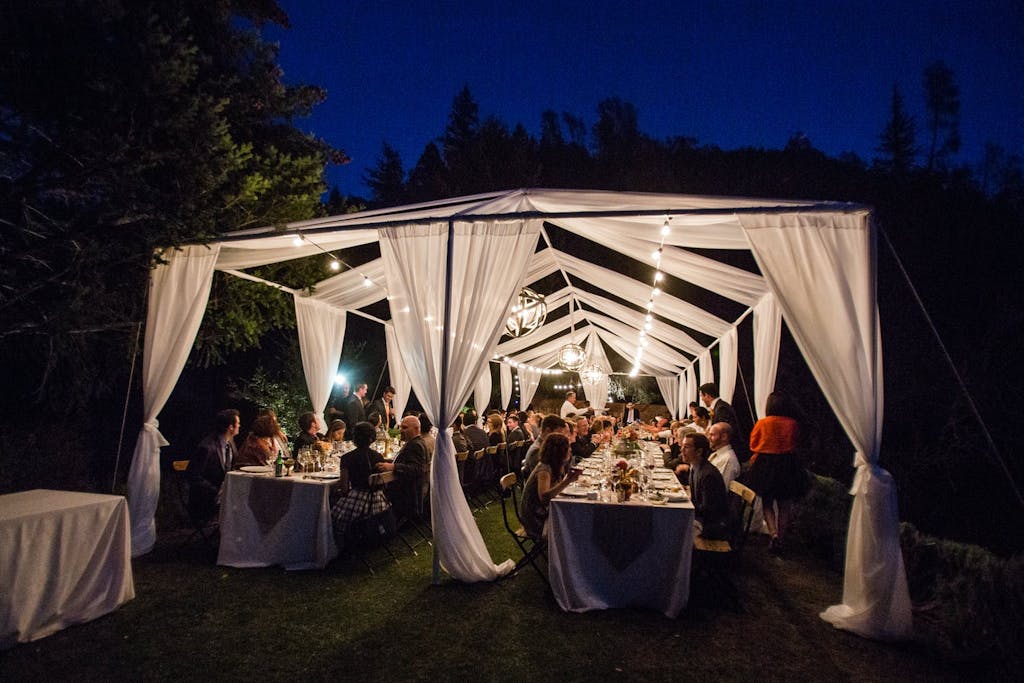 Open Wedding Tent With Illuminated White Drapery | PartySlate