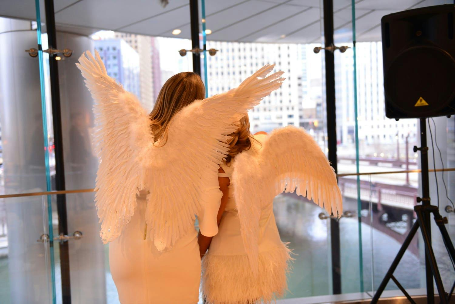 Two Women Wear Angel Wings at Baby Shower | PartySlate