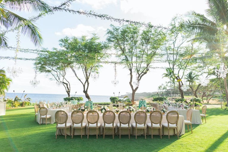 Hawaii beach wedding with beautiful greenery | PartySlate
