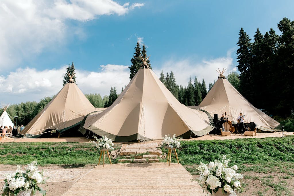 Three Connected Conical Wedding Tents Set in Colorado Mountains | PartySlate
