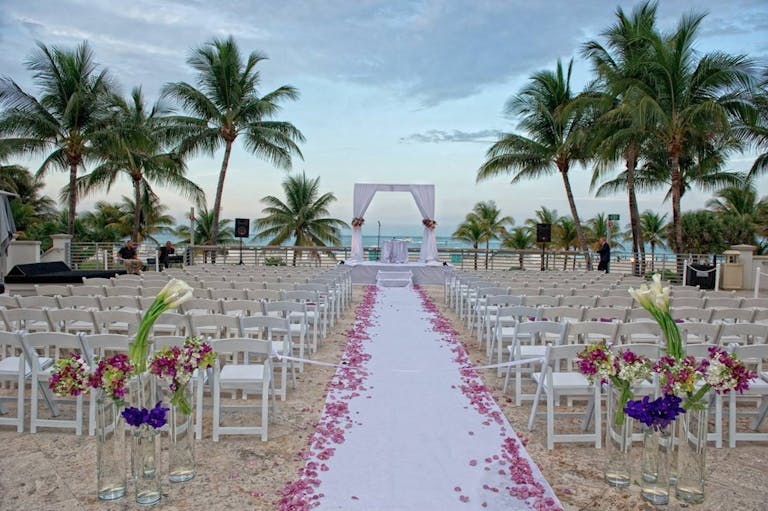 Beach wedding with beautiful palm trees | PartySlate