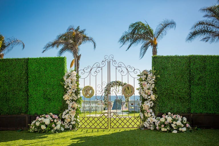 Beautiful gates leading to an outdoor beach wedding venue space | PartySlate